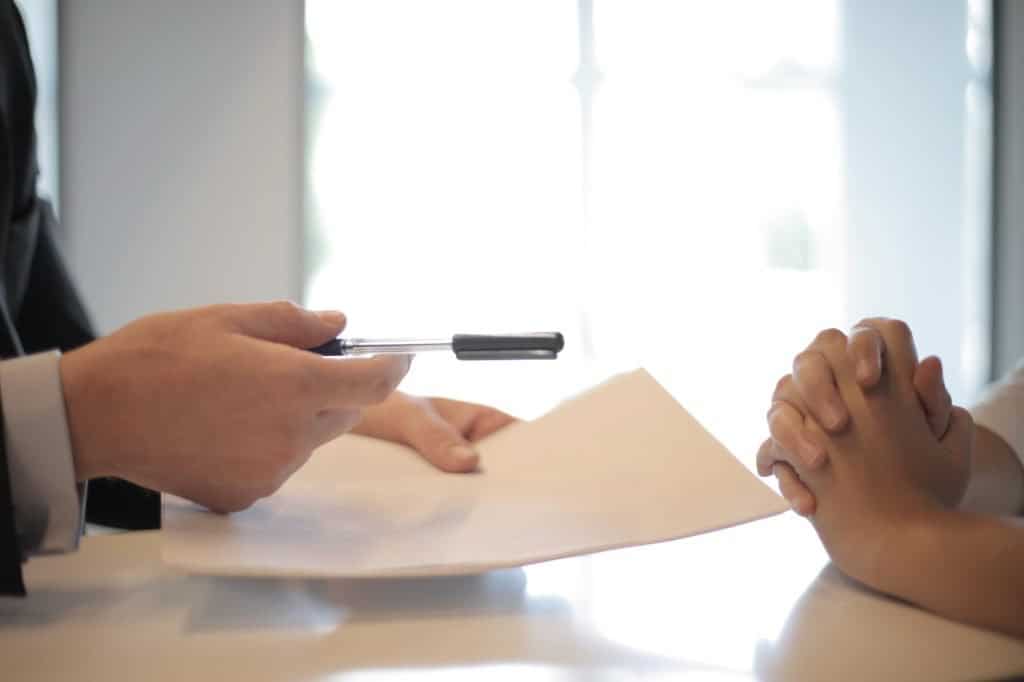 Crop Businessman Giving Contract To Woman To Sign